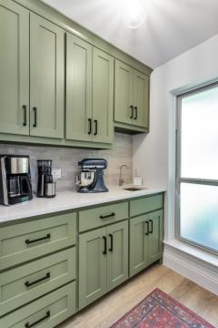 small kitchen with green cabinets
