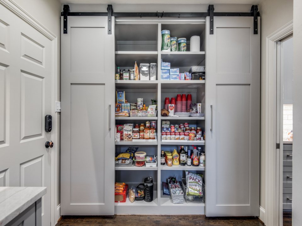 kitchen design trends - remodeled kitchen with barn door pantry